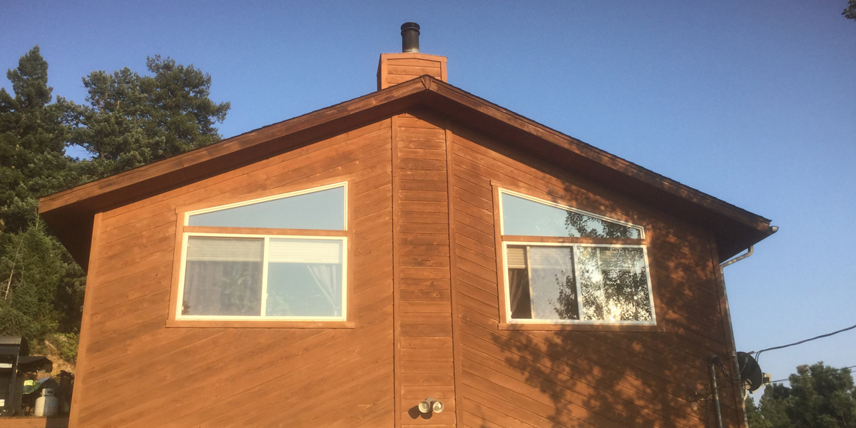 Image of conifer home after window replacement